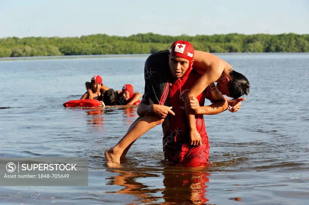 Red Cross lifeguards exercising in the Bahia de Jiquilisco bay, simulated rescue of a person drowning, El Salvador is the country most vulnerable to n...