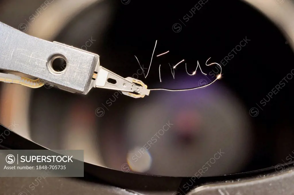 Actuator arm and head of a computer hard drive, with the engraved word virus