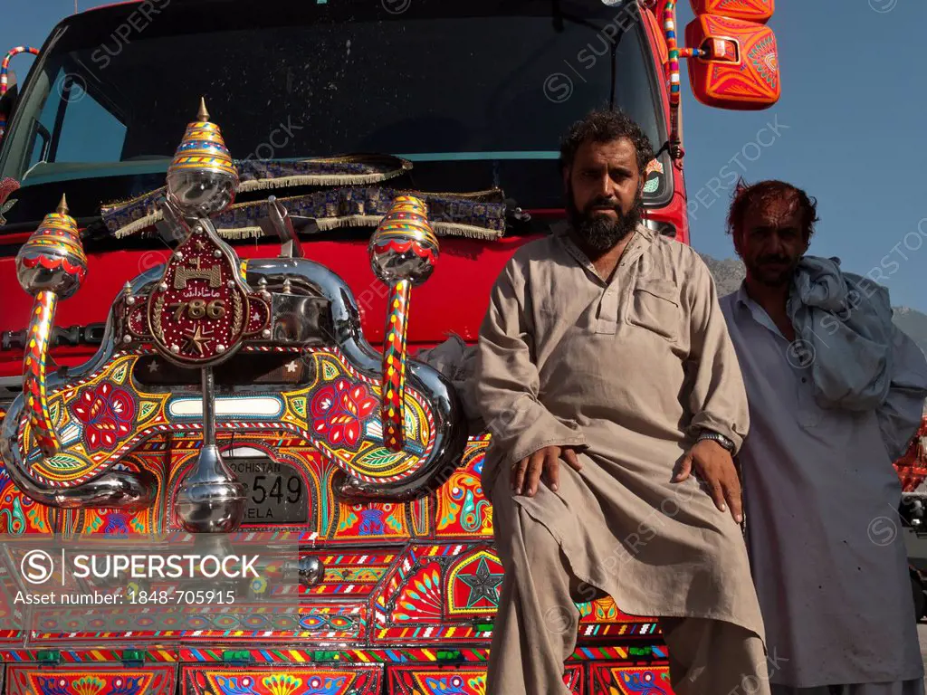 Pakistani truck driver, proud of his colorful vehicle, Gilgit, North West Frontier, Pakistan, South Asia