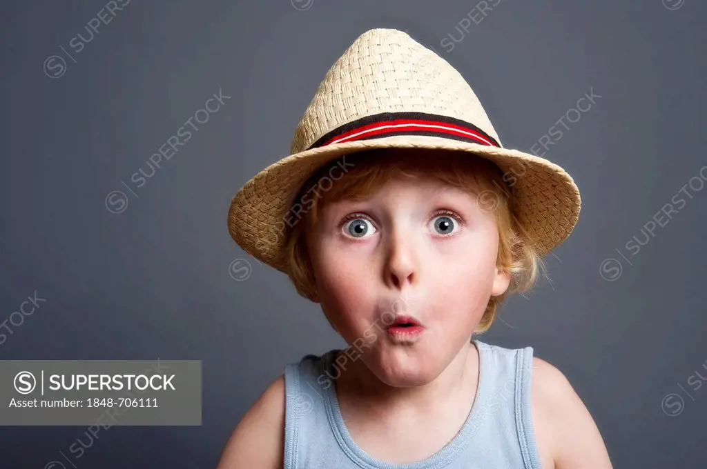 Five-year-old boy wearing a hat, astonished face, funny portrait