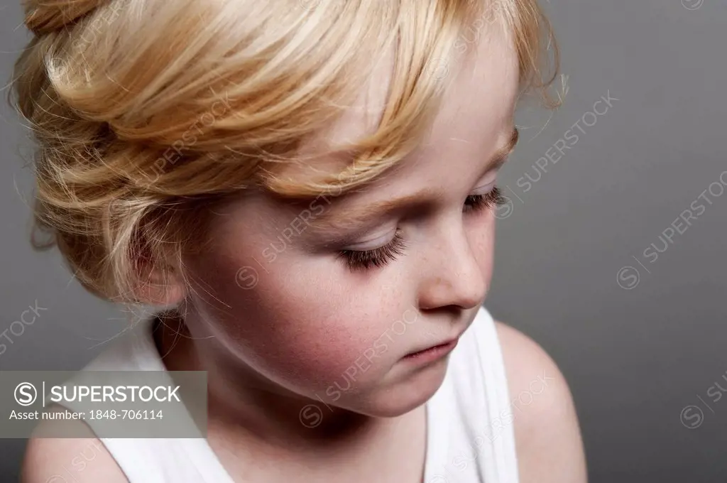 Five-year-old boy looking down, portrait