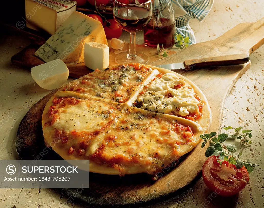 Neapolitan cheese pizza with mozzarella, gorgonzola, fontina and semi-solid goat's cheese, tomatoes seasoned with garlic and oregano, Italy