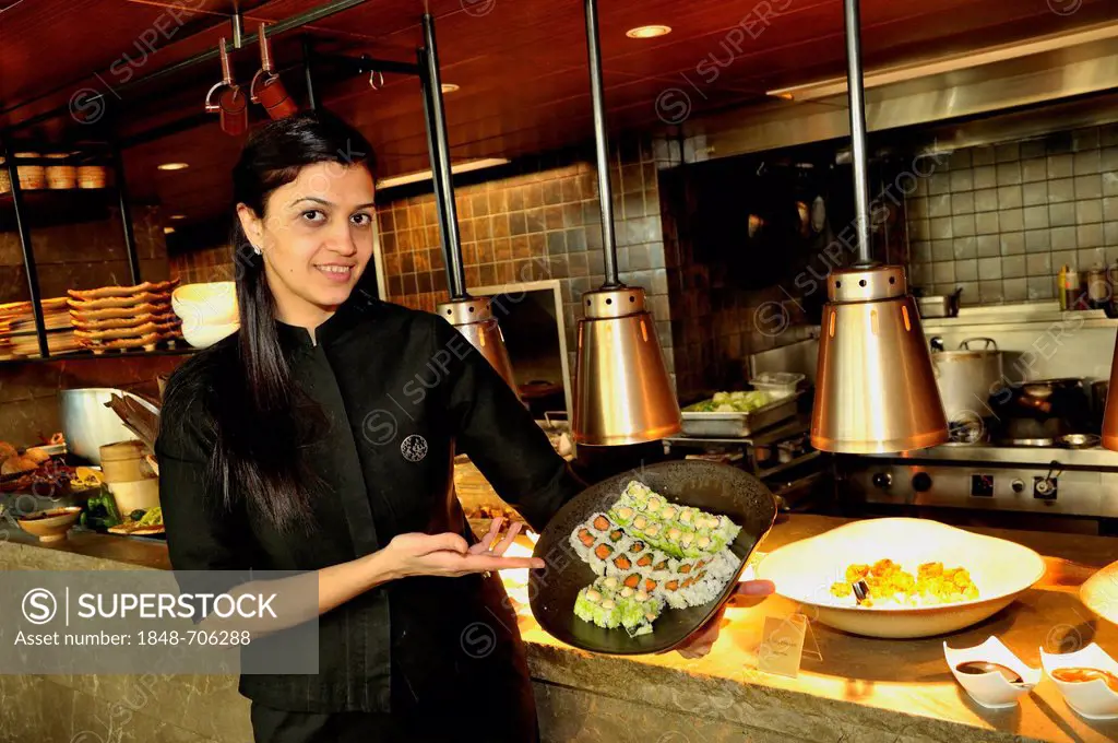 Waitress holding sushi in the restaurant Chinar, Baku, Azerbaijan, Caucasus, Middle East, Asia