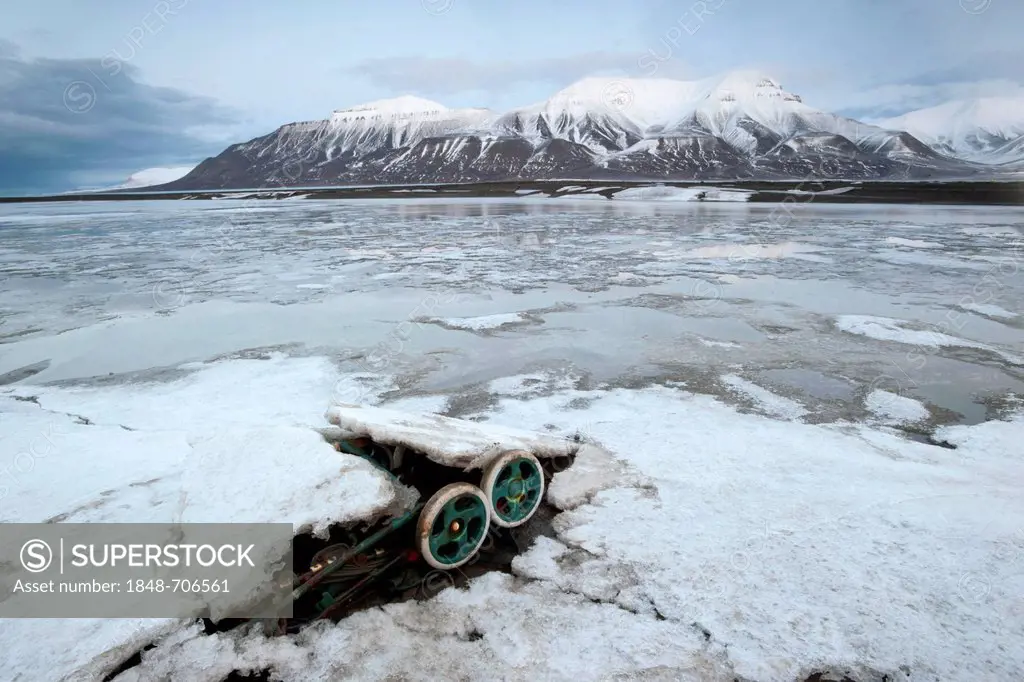 A discarded pram, waste on the coast of the Adventfjorden bay, Longyearbyen, Spitsbergen, Svalbard, Norway, Europe