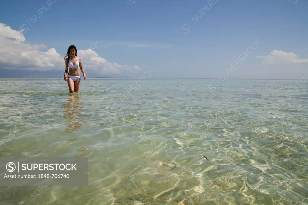 Young pretty Asian woman in a bikini on an idyllic beach on Pandan Island in Honda Bay near Puerto Princesa, Palawan Island, Philippines, Asia