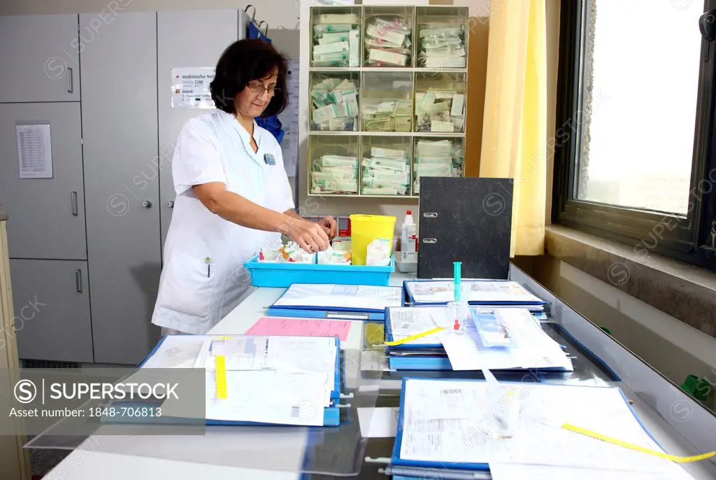 Nurse preparing the documents and medicine for patients in the nurse's station of a hospital