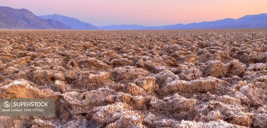Salt crust on the Devil's Golf Course, sunset, Panamint Range, Black Mountains, Death Valley National Park, Mojave Desert, California, United States o...