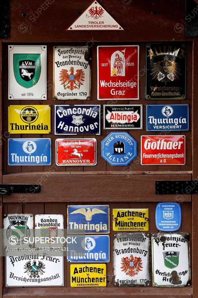 Collection of old tin signs of German and Austrian insurance companies
