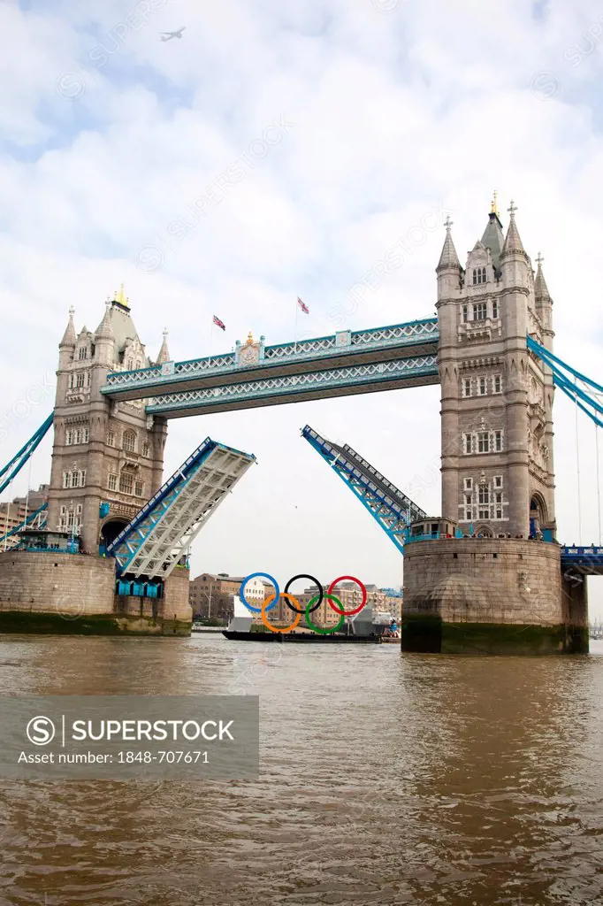 Giant Olympic Rings are floated down the River Thames and passing open Tower Bridge to promote the Olympic Games in London 2012, London, England, Unit...
