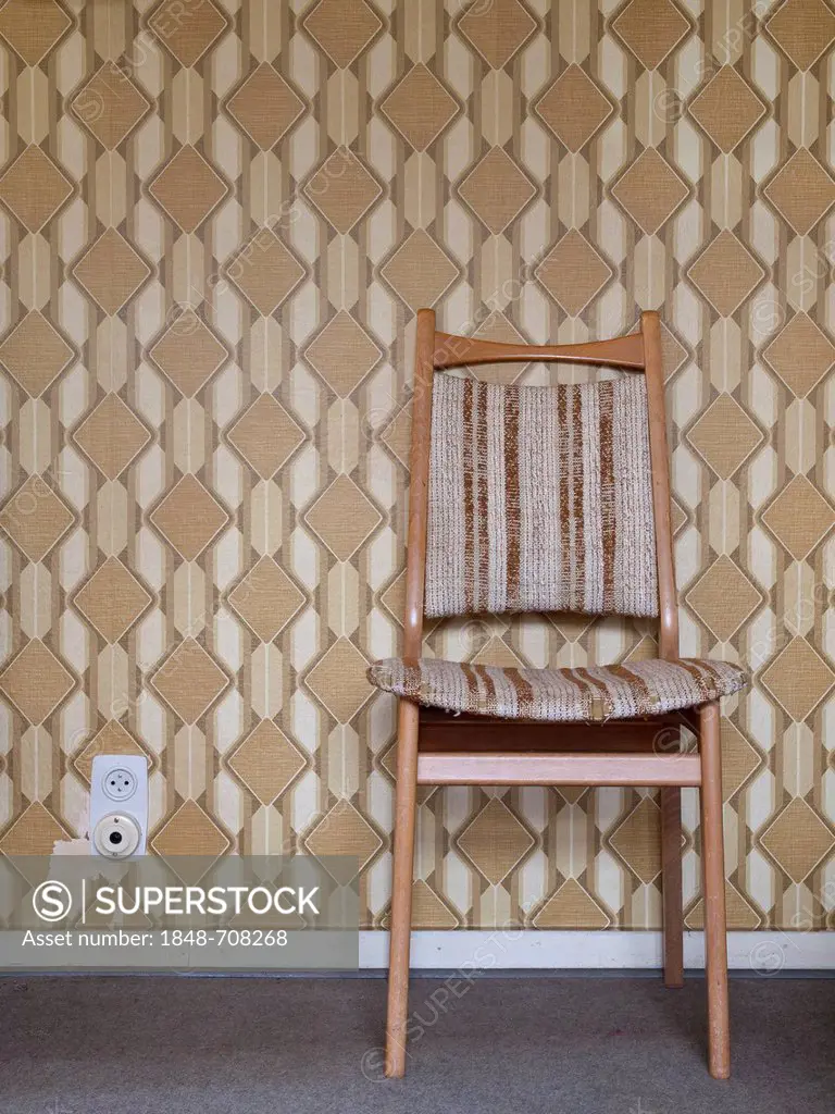Chair in front of wallpaper