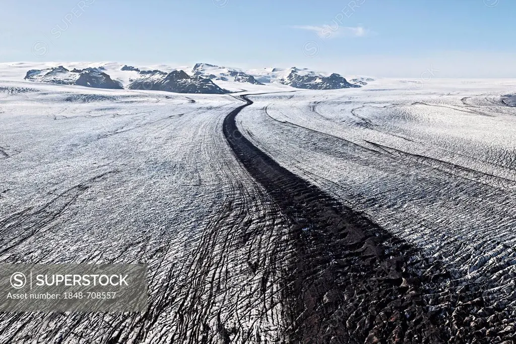 Aerial view, lines and structures consisting of ice, snow, volcanic ash and black lava on the south side of Vatnajoekull glacier, Iceland, Europe