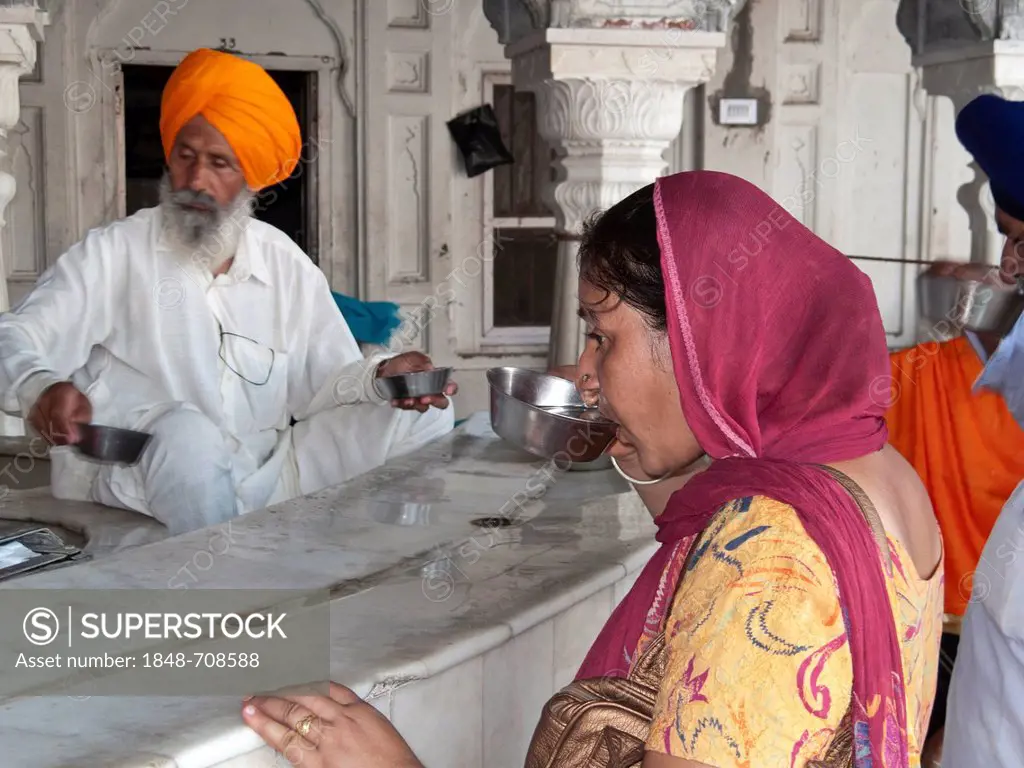 Serving water to the pilgrims is part of the Sikh philosophy, Amritsar, Punjab, India, Asia