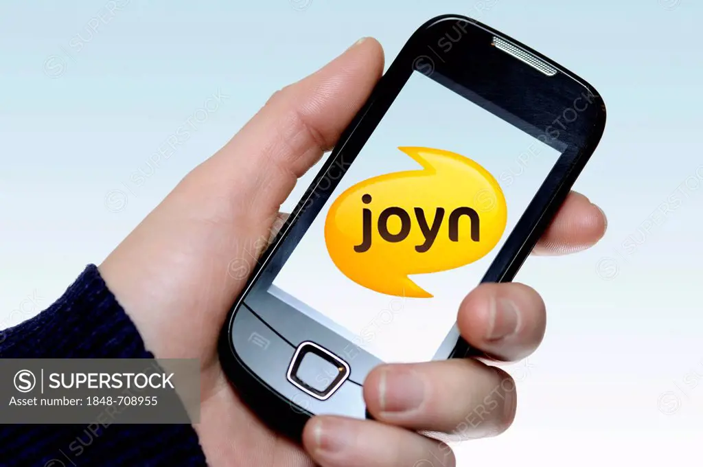 Hand holding a smartphone with a Joyn logo