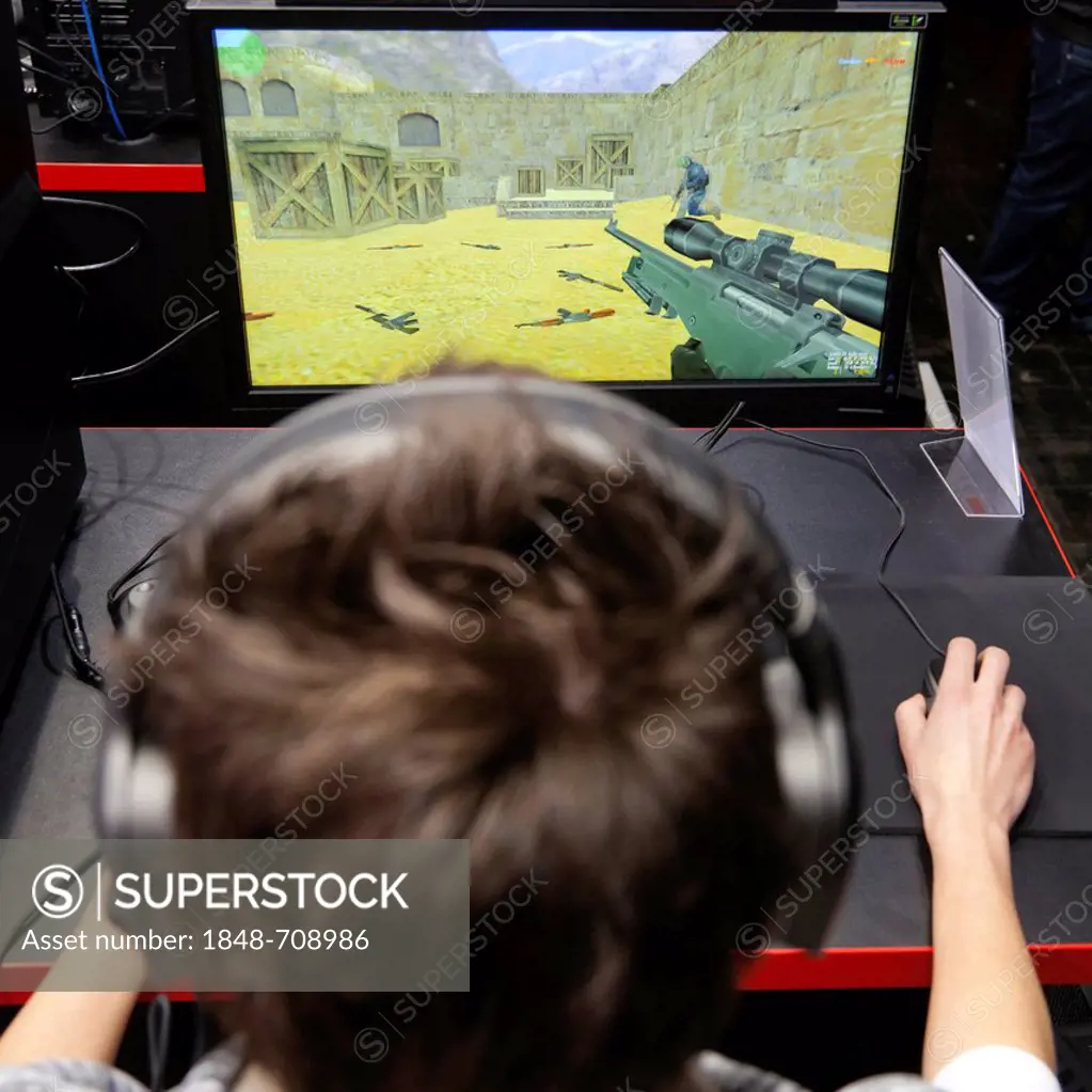 Teenager playing Counter Strike, a computer game, CeBIT international computer expo, Hannover, Lower Saxony, Germany, Europe