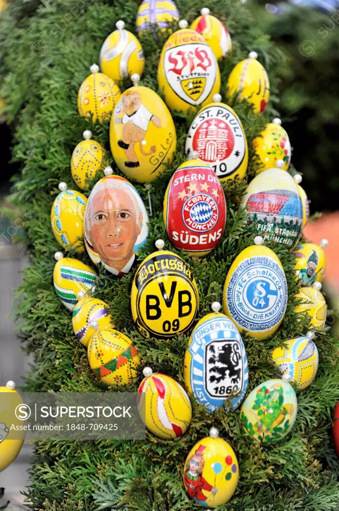 Easter eggs painted with various crests from Bundesliga football clubs decorating the Easter fountain 2012, Schechingen, Baden-Wuerttemberg, Germany, ...