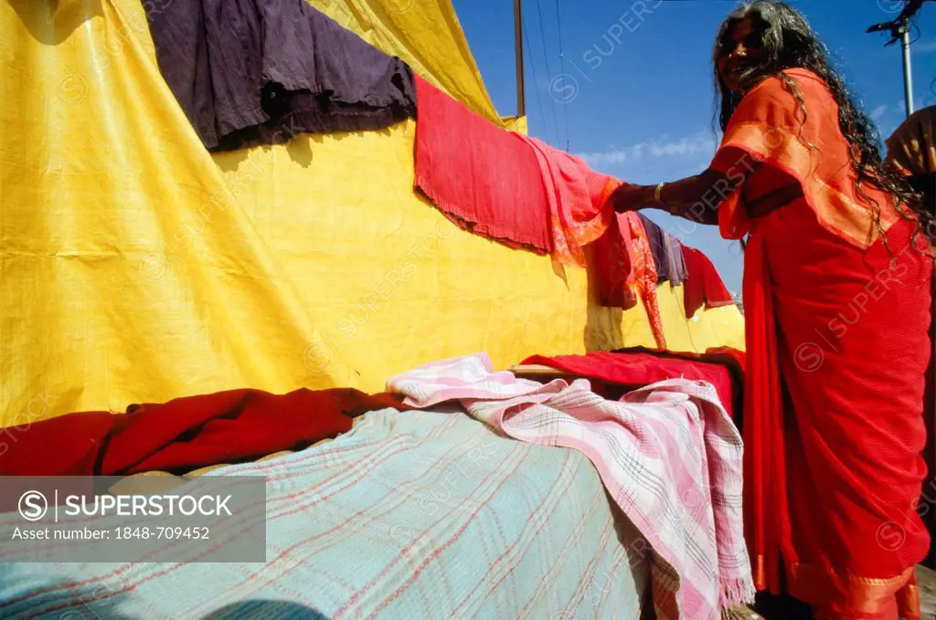 Woman drying laundry in the hot winds of Varanasi, Uttar Pradesh, India, Asia