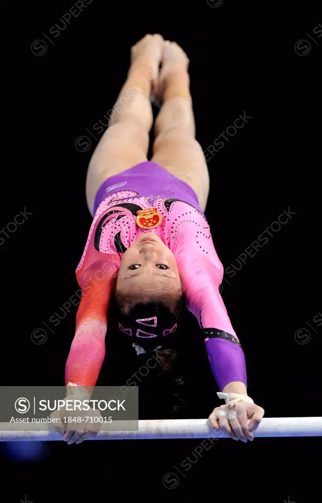 Qiushuang Huang, CHN, performing on uneven bars, EnBW Gymnastics World Cup, 11 to 13 Nov 2011, 29th DTB Cup, Porsche-Arena, Stuttgart, Baden-Wuerttemb...