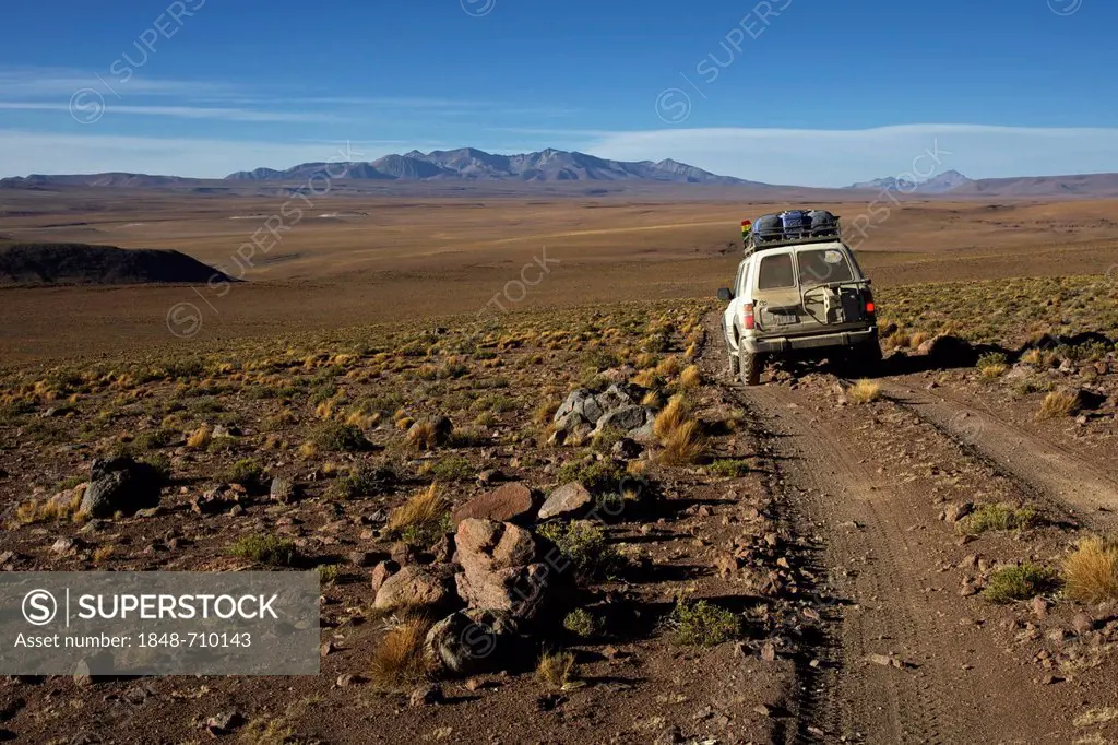 Off-road vehicle on a gravel road, Atacama Desert, Altiplano, southern Bolivia, South America