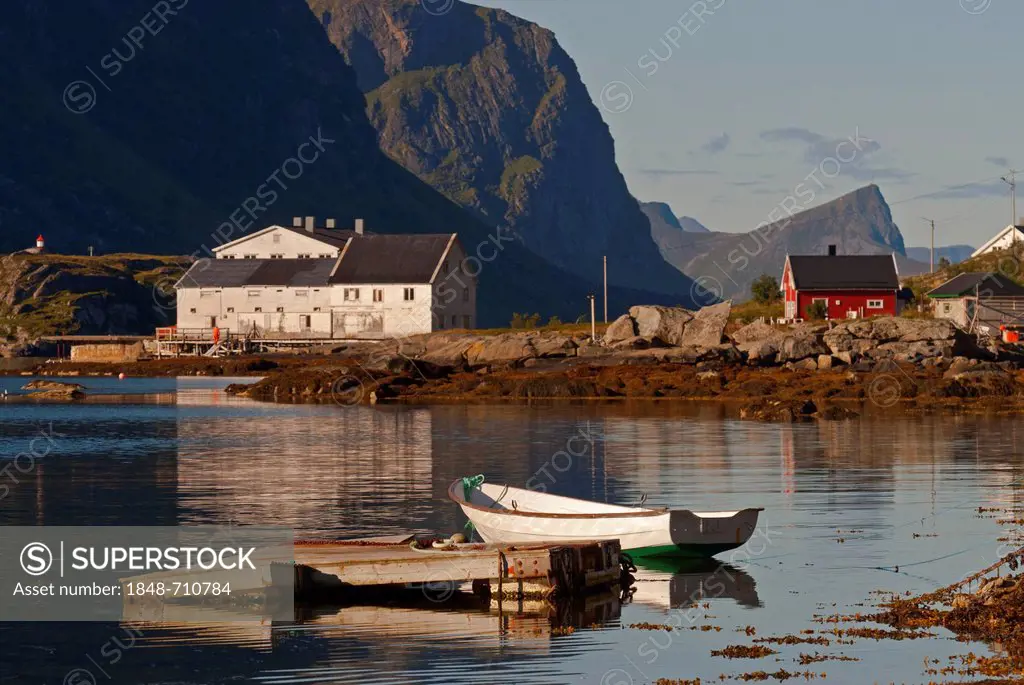 Houses and a boat illuminated by warm morning light, at Mærvollspollen, Nordland, Norway, Europe