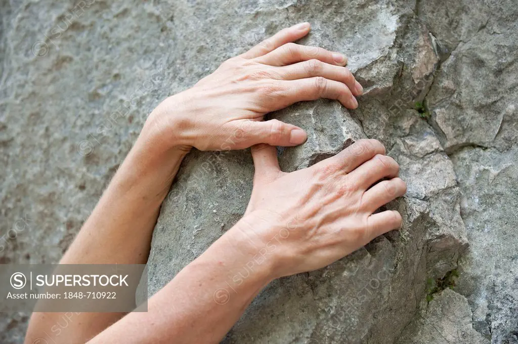Hands of a mountaineer, climber, on a rock, rock climbing, Arco, Italy, Europe