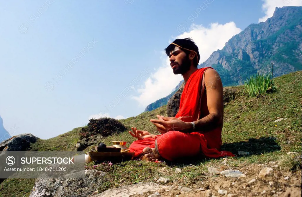 Praying priest sitting above Badrinath, Uttarakhand, formerly Uttaranchal, India, Asia