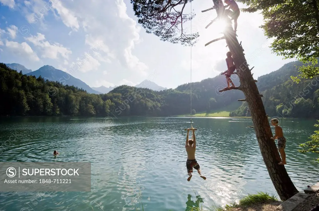 Children having fun on Lake Alatsee near Fuessen, Allgaeu region, Bavaria, Germany, Europe