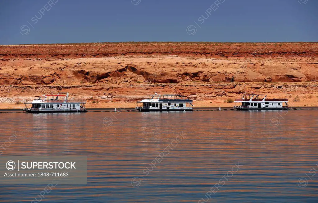House boats for hire are moored in the harbour of Antelope Point Marina with Tower Butte at back, Lake Powell, Wahweap Marina, Glen Canyon National Re...