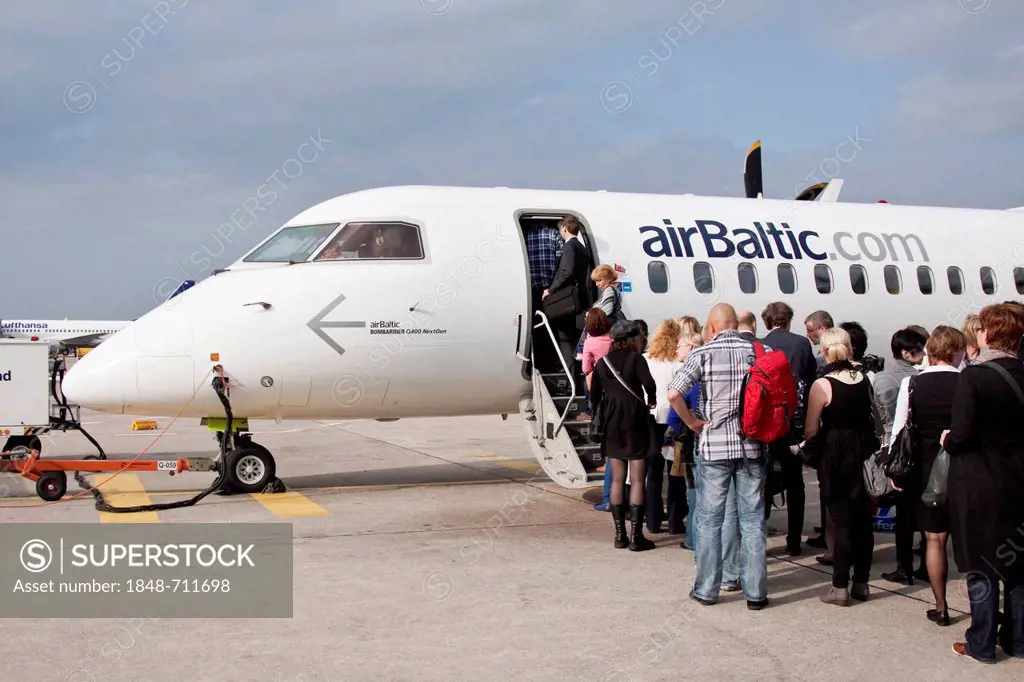 Passengers boarding an Air Baltic Bombardier Q 400 Next Gen aircraft, Berlin Tegel Otto Lilienthal Airport, Berlin, Germany, Europe