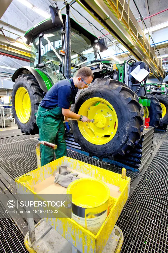 Wheels are given a coat of paint in the tractor production section at the European headquarters of the American agricultural machinery manufacturer Jo...