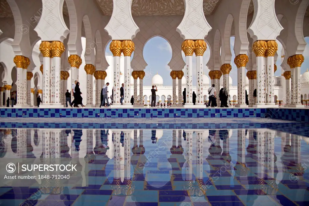 Colonnades reflected in a pool of the Sheikh Zayed Mosque in Abu Dhabi, United Arab Emirates, Asia
