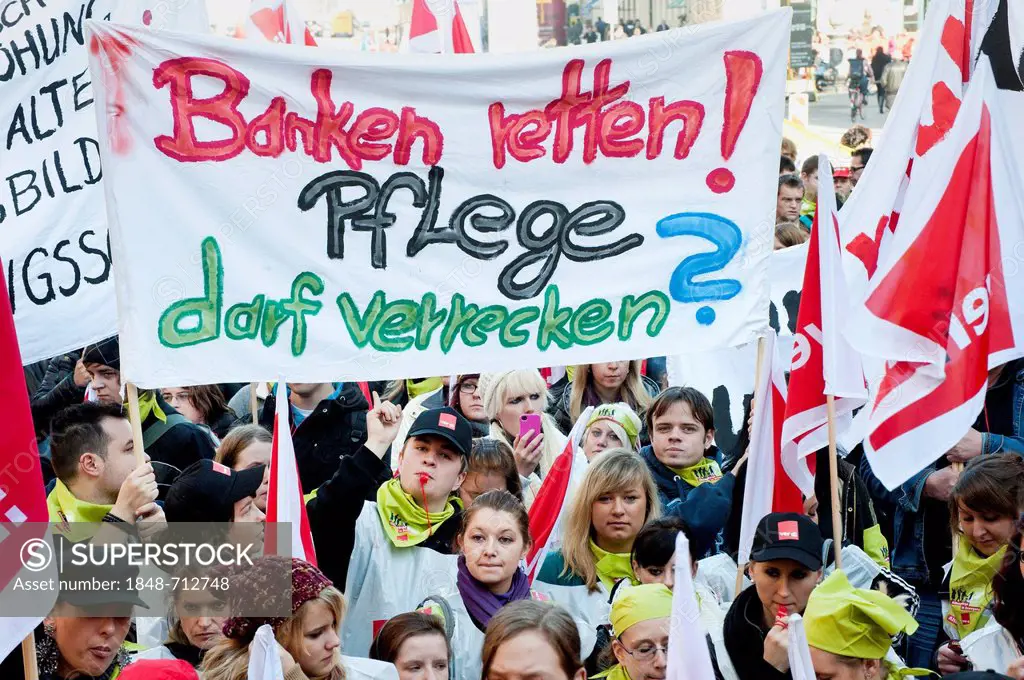 Banner Banken retten! Pflege darf verrecken, German for Saving the banks. Letting care go to pieces, rally with 1500 apprentices from Bavarian nursing...