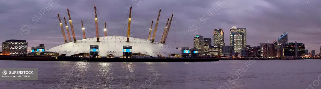 View across the River Thames of Canary Wharf with the Millennium Dome in the foreground, dusk, London, England, United Kingdom, Europe