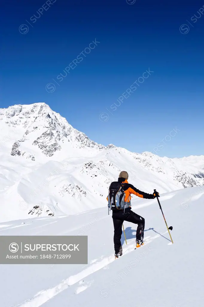 Cross-country skier during the ascent to Hintere Schoentaufspitze Mountain, Solda, with Ortler Mountain at the rear, Alto Adige, Italy, Europe