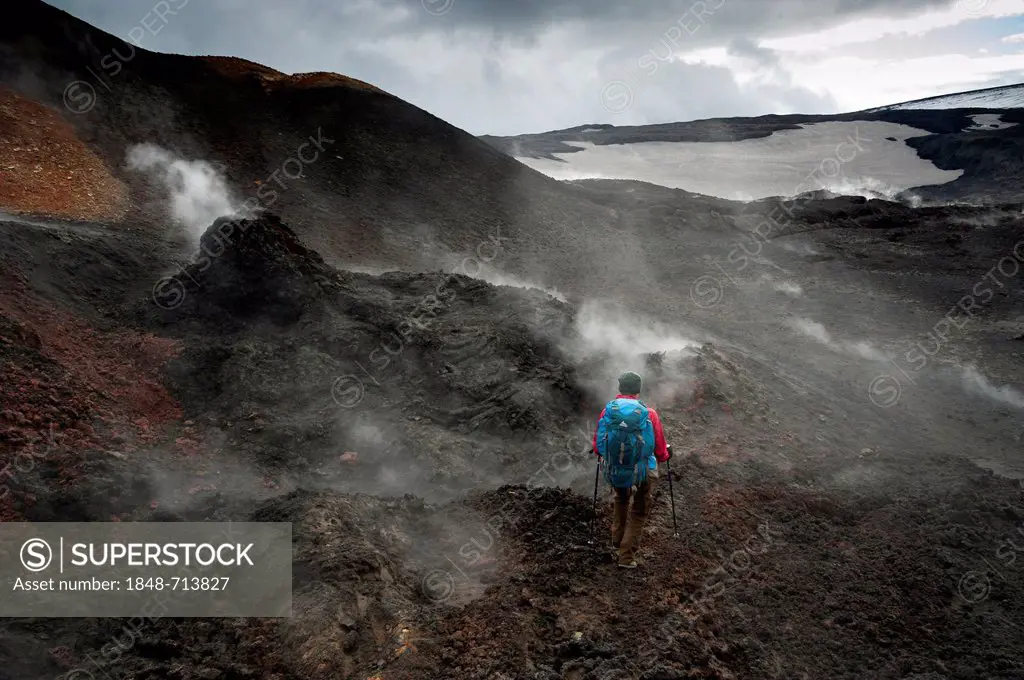 Hiker in the steaming Goðahraun, Godahraun lava field, solfatars on the Fimmvoerðuháls volcano, hiking trail to the Fimmvoerðuháls, Fimmvoerduhals pla...