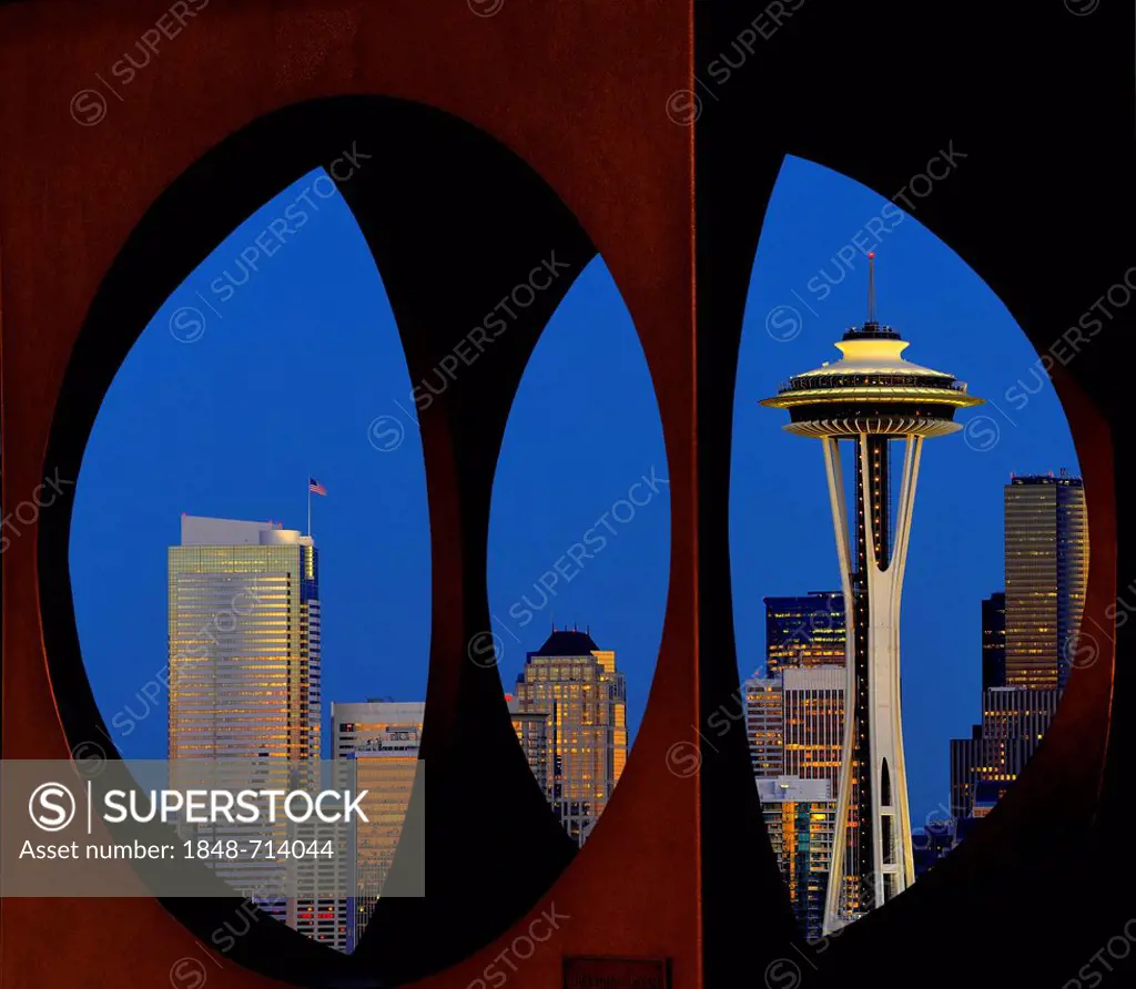 View through steel sculpture Changing Form by Doris Chase, night view, skyline of Seattle financial district with Space Needle, Columbia Center, forme...