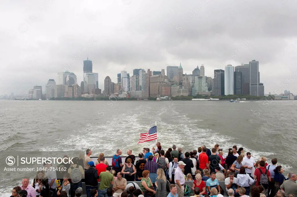 View from a boat with many people over the Hudson River towards the skyline and skyscrapers, Financial District, Lower Manhattan, New York City, USA, ...