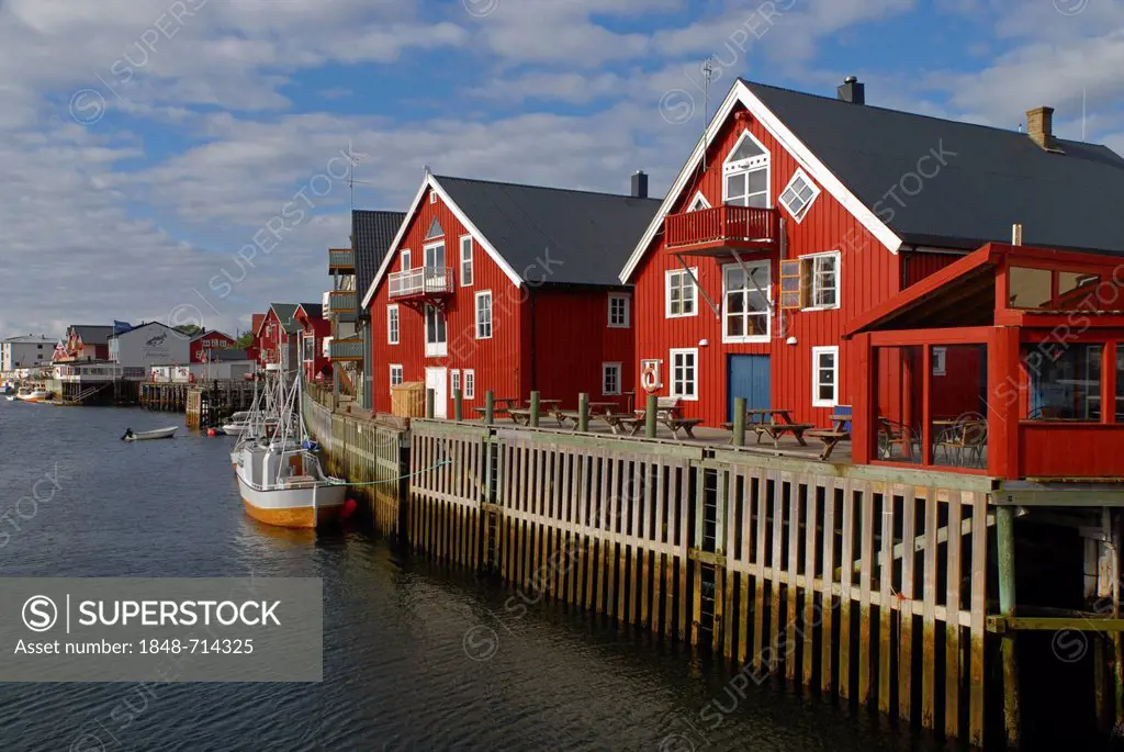 Fishing boats and typical red houses in Henningsvær, Lofoten, Nordland, Norway, Europe