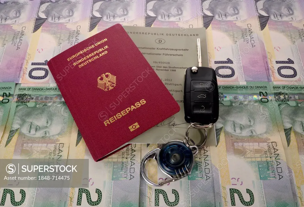 Passport of the Federal Republic of Germany, international driving license, an ignition key and various Canadian dollar banknotes