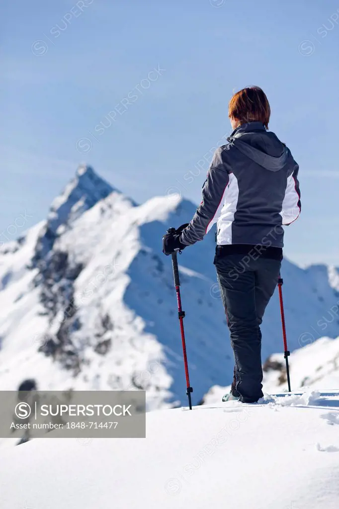 Mountaineer standing on Roethenspitz mountain above the Penser Joch ridge, view of the summit of Penser Weisshorn mountain, also known as Sarntaler We...
