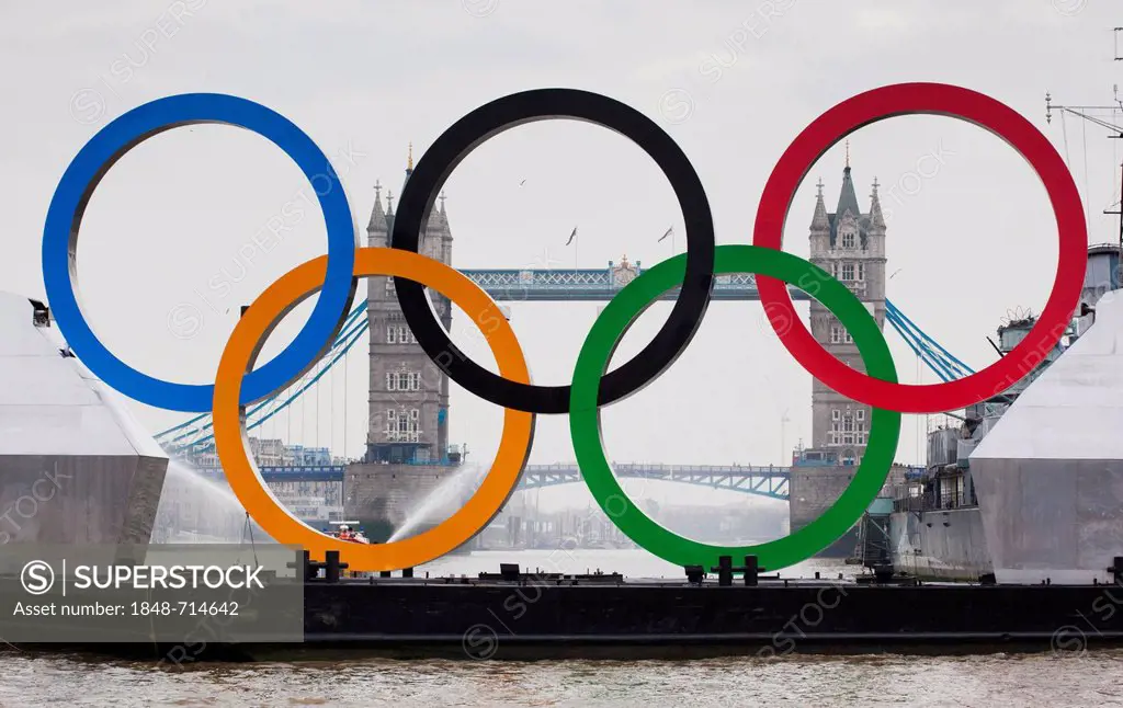 Giant Olympic Rings are floated down the River Thames in front of Tower Bridge to promote the Olympic Games in London 2012, London, England, United Ki...