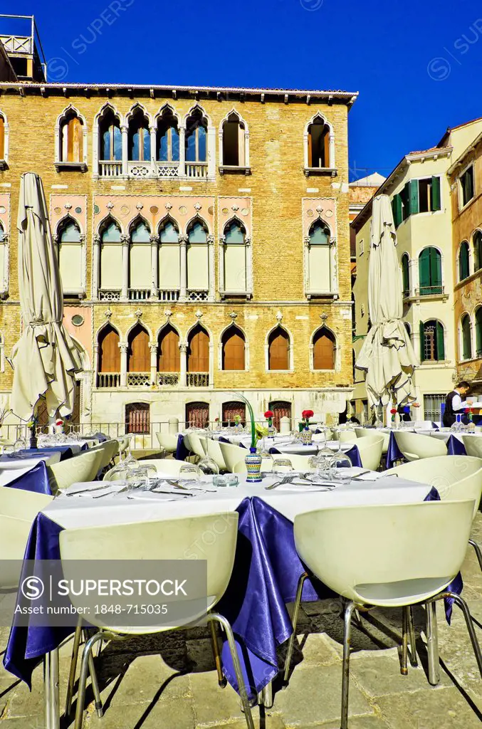 Chairs and tables outside a restaurant in Venice, Venezia, Veneto, Italy, Europe