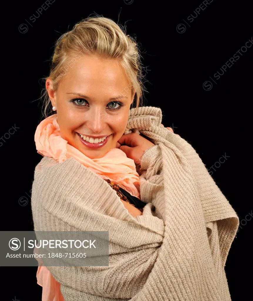 Young woman wearing a sweater and a scarf, cozy