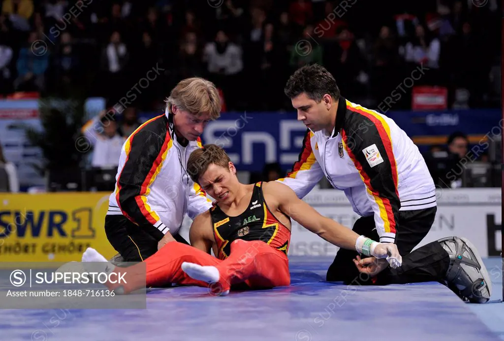 Philip Boy, GER, on ground after fall from high bar, with coaches, EnBW Gymnastics World Cup, 11 to 13 Nov 2011, 29th DTB Cup, Porsche-Arena, Stuttgar...