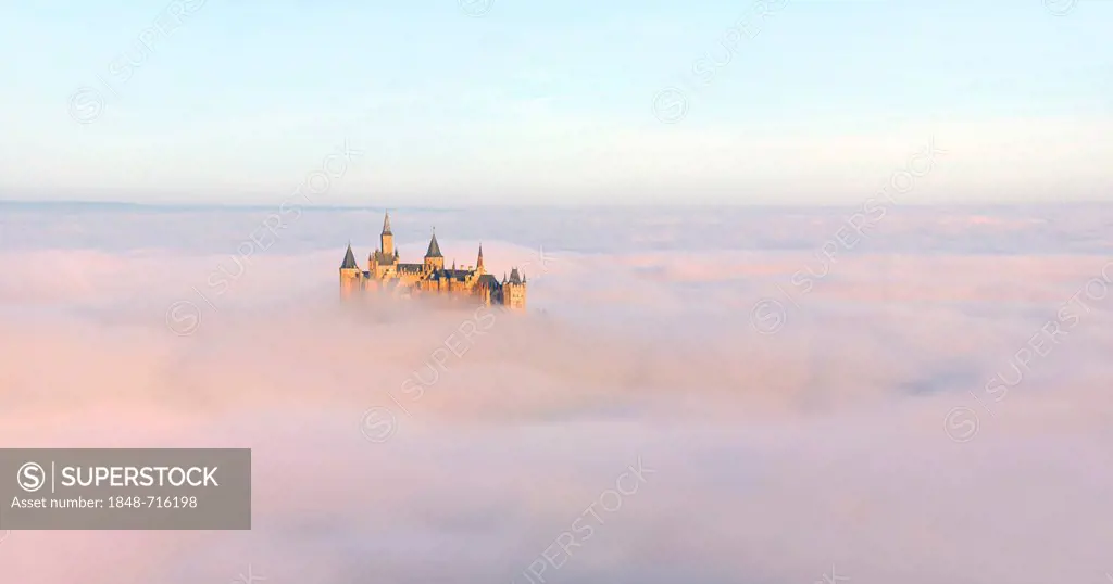 Burg Hohenzollern castle in morning light, early morning fog, Swabian Alb, Baden-Wuerttemberg, Germany, Europe
