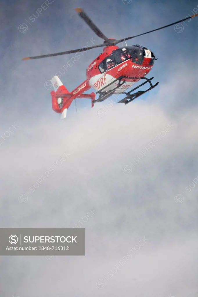 Rescue helicopter approaching, rescue operation with a rescue helicopter in the Thuringian Slate Mountains, Thuringia, Germany, Europe