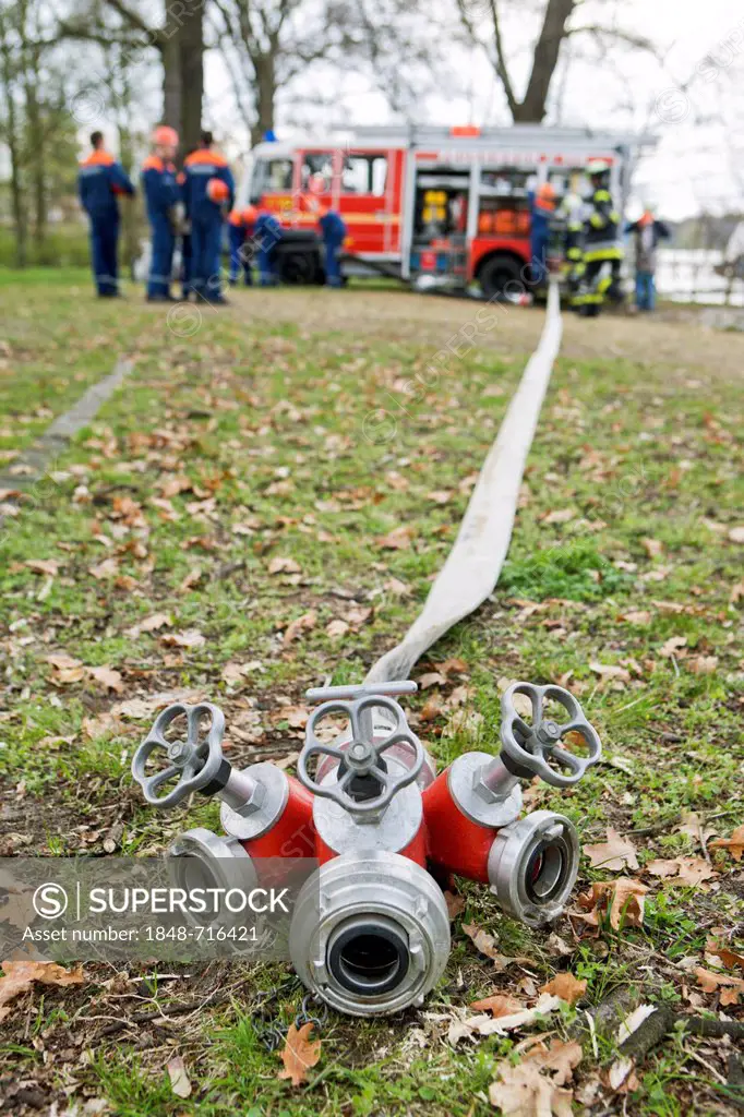 Gatow voluntary fire brigade, youth fire brigade, during an exercise to establish a suction tube on the shore of the Havel river, Berlin, Germany, Eur...