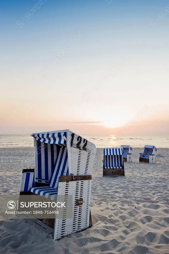 Roofed wicker beach chairs on the beach at sunset, List, Sylt, Schleswig-Holstein, Germany, Europe