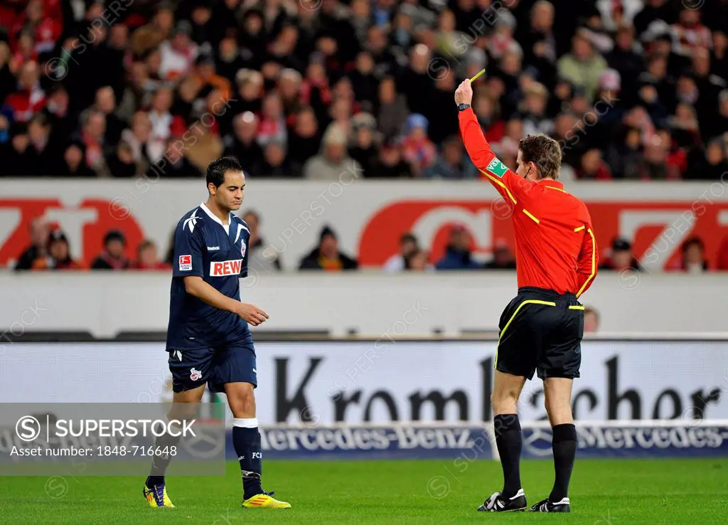 Referee Dr. Felix Brych, showing yellow card to Ammar Jemal, 1. FC Koeln, warning, Mercedes-Benz Arena, Stuttgart, Baden-Wuerttemberg, Germany, Europe