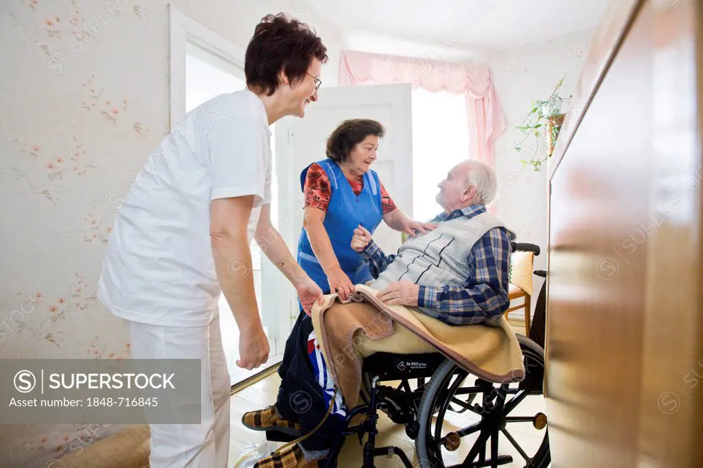 Ambulatory care of the German Red Cross, nurse Anke Lehmann attending an old married couple, as she does every morning, helping the wife to lift her h...