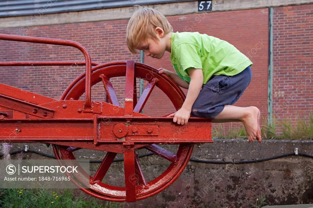 Little boy playing on an old crane at the Hafenmuseum, harbour museum, Hamburg Wilhelmsburg, Germany, Europe